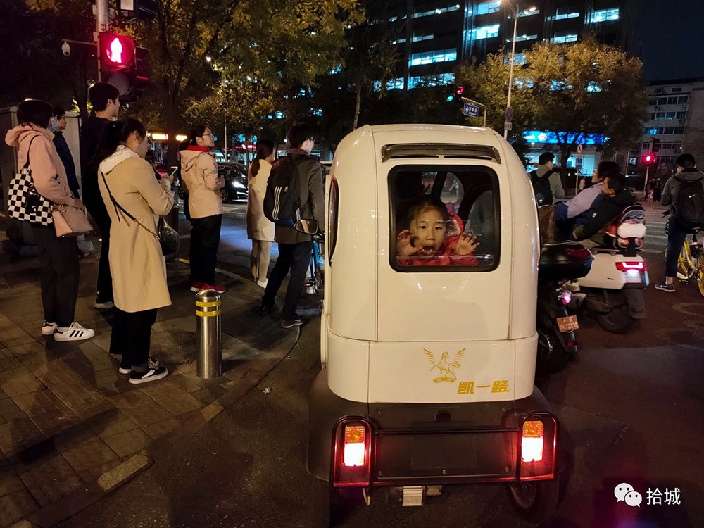 北京-2019年11月1日，放学回家的小朋友在车里自娱自乐。拾城 浦峰