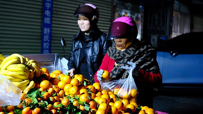 顾客挑选水果。图片来源：史子杨/摄
