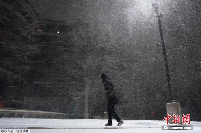 当地时间2月15日，美国得克萨斯州遭遇冬季风暴袭击，全州气温均低于零摄氏度。图为一名行人走在暴风雪中。