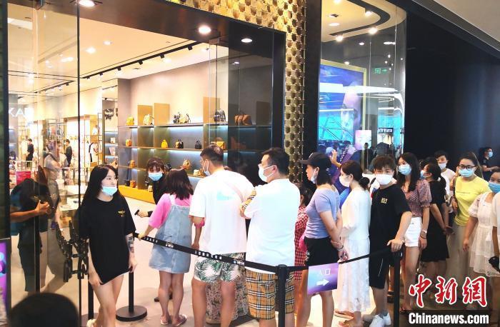 图为游客在三亚国际免税城内排队进店购物。　尹海明 摄