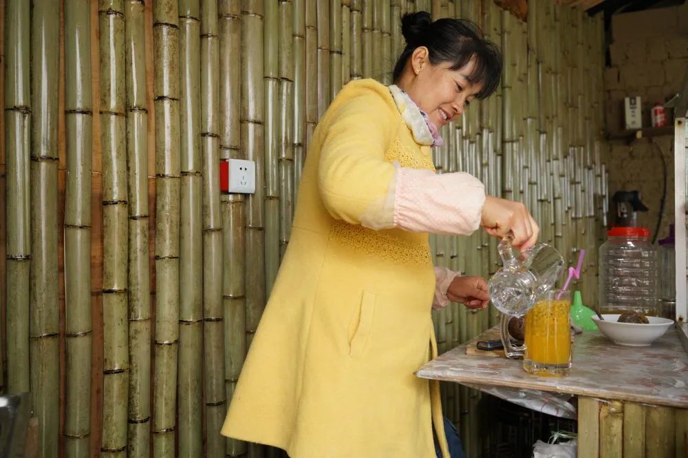 囊贤菊正在为客人制作百香果饮品。张雯 摄