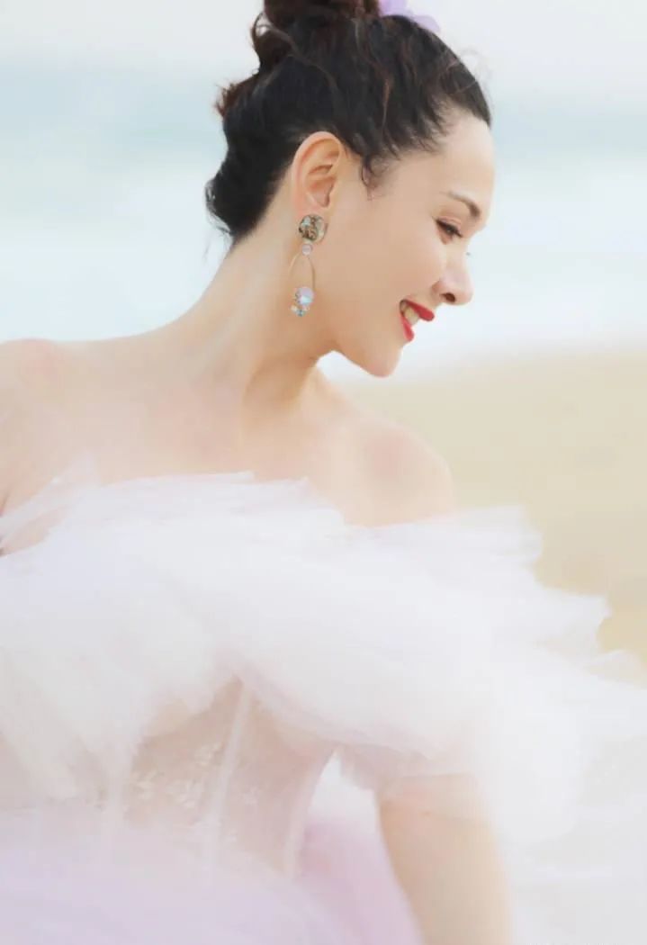 一张程莉莎小时候的照片,看得出父母把她打扮得很好,白色蕾丝边裙子