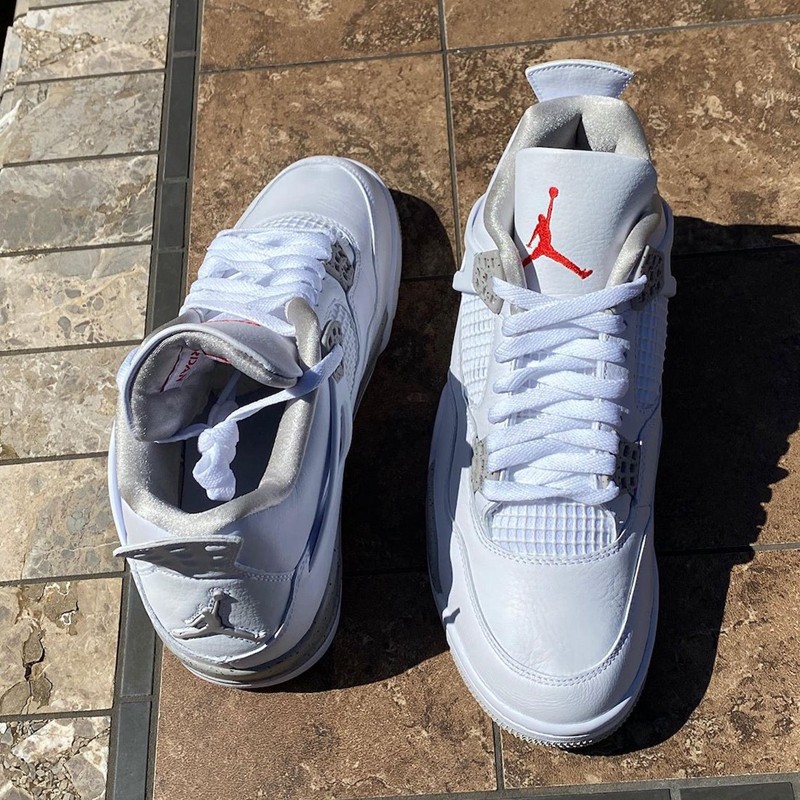 整体采用细腻柔软的白色皮革构建鞋身,鞋舌鲜红 jumpman logo 提亮