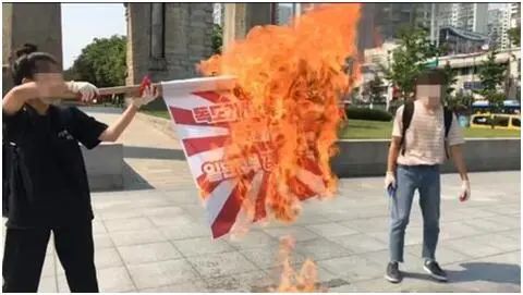 韩国学生在首尔独立门前焚烧“旭日旗” 图源：韩联社引自韩国大学生进步联合会YouTube频道