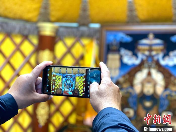 图为民众用手机拍摄蒙古国地毯。孙睿 摄