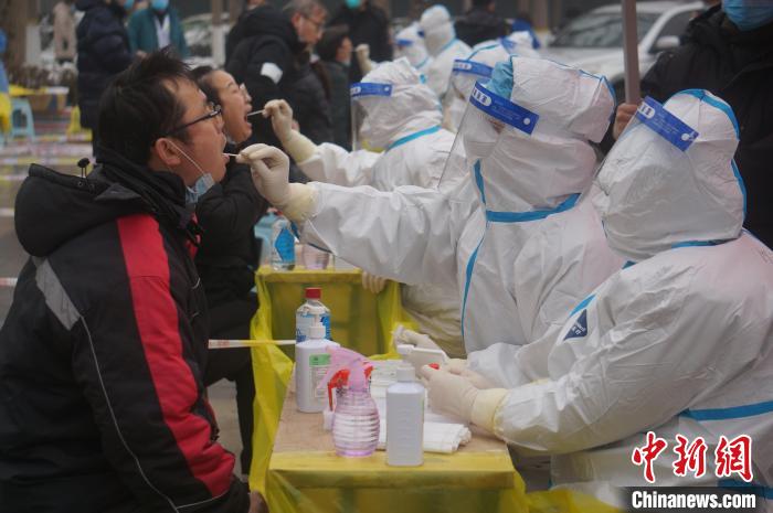 图为医务人员为郑州市民做咽拭子采样。韩章云 摄