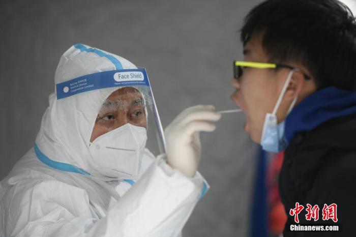 资料图：在天津西青区大寺镇疫情管控区内，一位市民正在进行核酸检测。 中新社记者 佟郁 摄