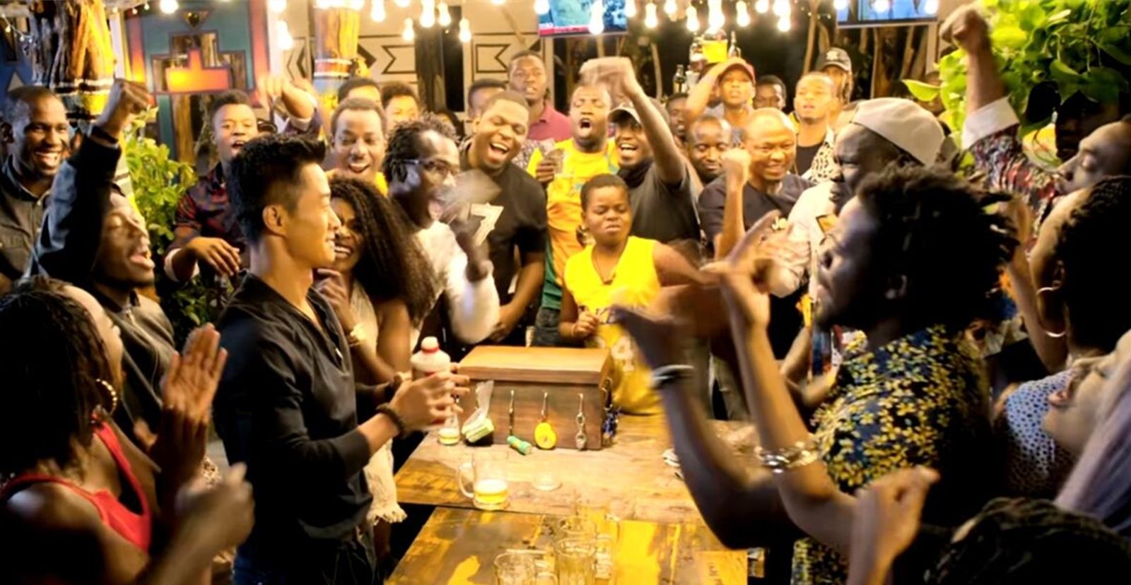 吴京在一群人的簇拥之下,和一位黑人老哥进行茅台喝酒比赛,双方不停地