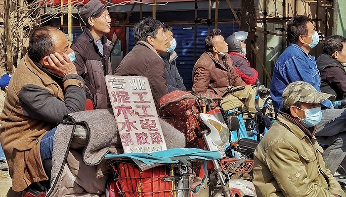 2022年2月25日,武汉市青山区,在路口等活的农民工.