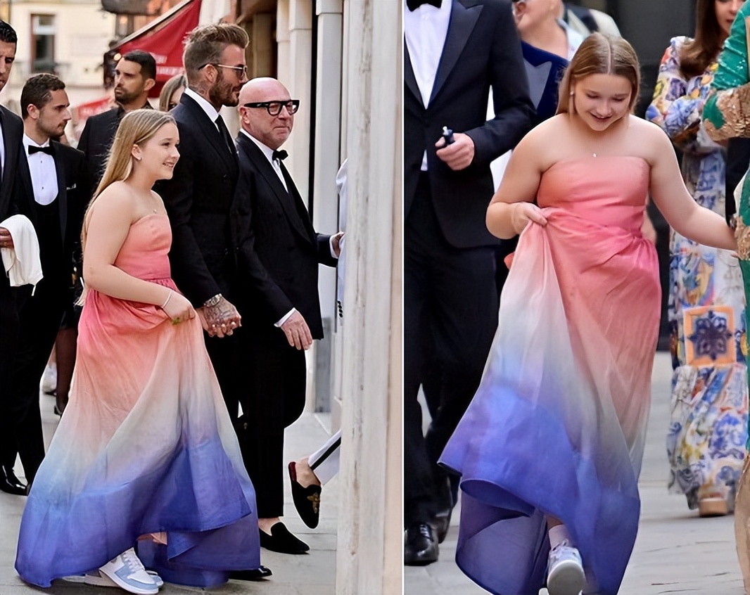 贝克汉姆女儿穿抹胸裙手提裙摆好俏丽紧握爸爸手掌张嘴大笑