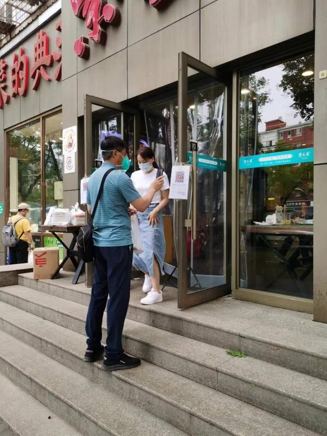 顾客进店前进行扫码登记。周学津摄