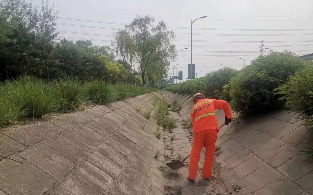 ▲工作人员提前清理高速公路上的排水沟,确保降雨时排水顺畅。首发养护供图