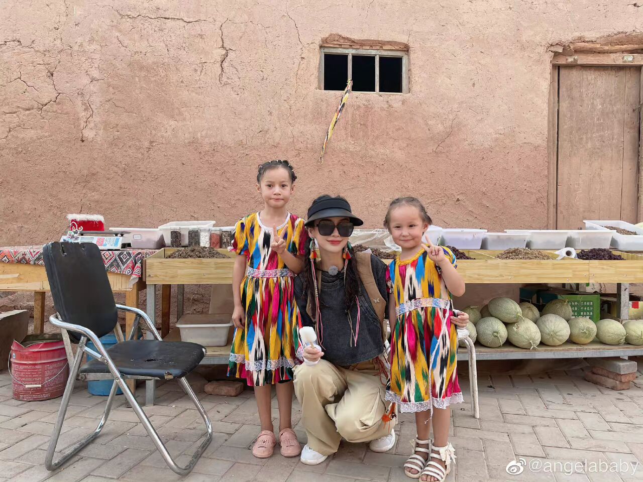 baby晒新疆美照，梳双马尾戴流苏耳饰，蹲地与小朋友合照亲和力十足休闲区蓝鸢梦想 - Www.slyday.coM