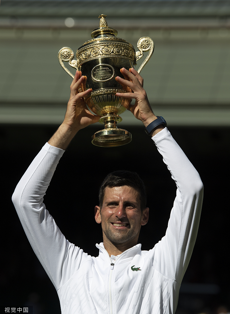 德约高举温网奖杯.