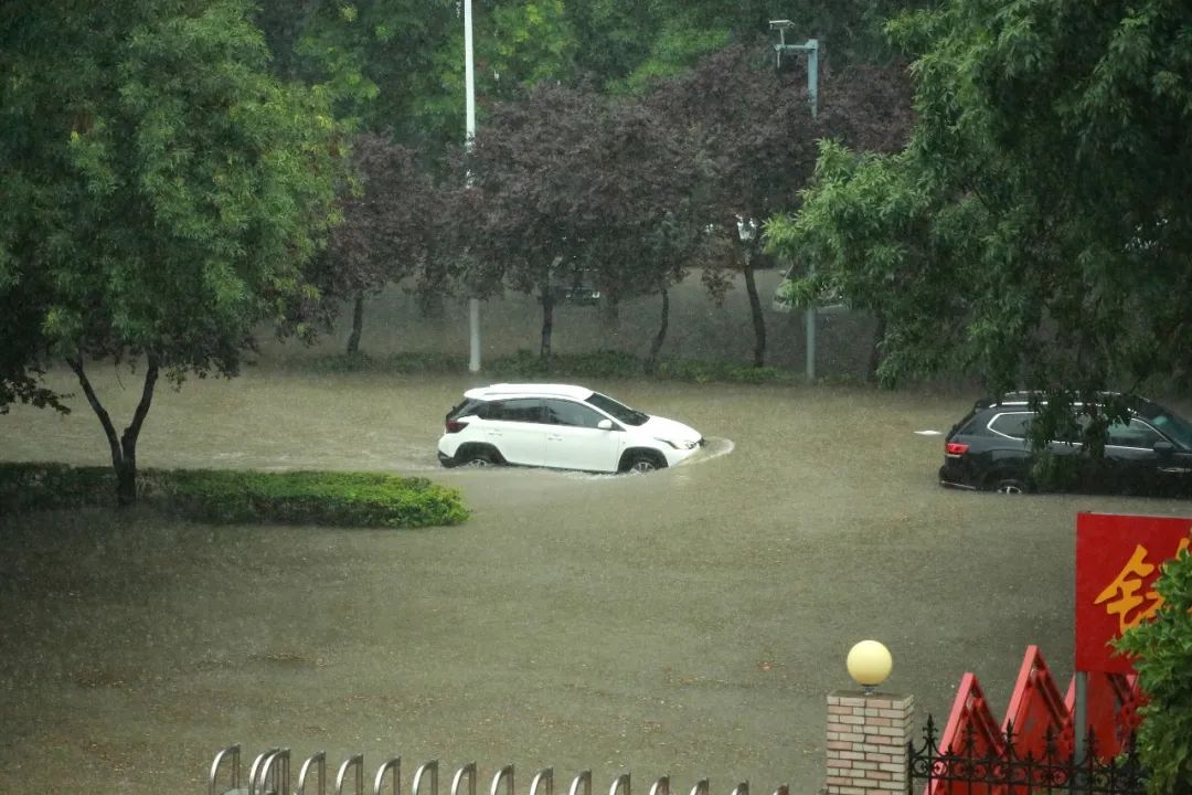 资料图：7月5日，河南安阳持续强降雨使海河大道积水严重，路上车辆缓慢行驶。图片来源：人民视觉