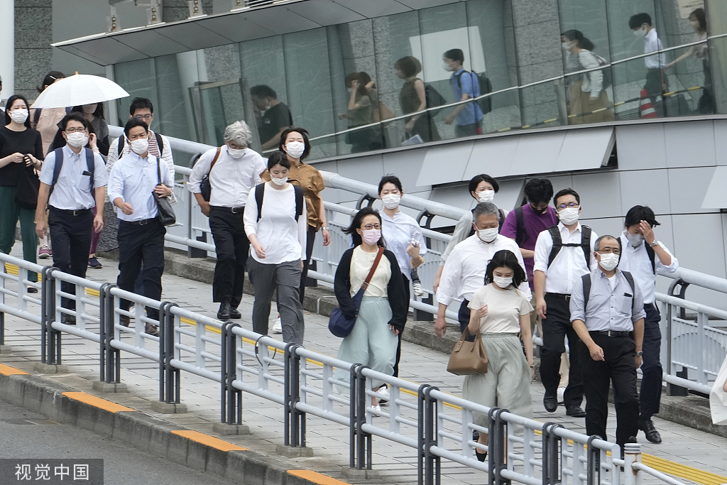 当地时间2022年7月22日,日本东京,人们在早高峰时间戴着口罩上下班.