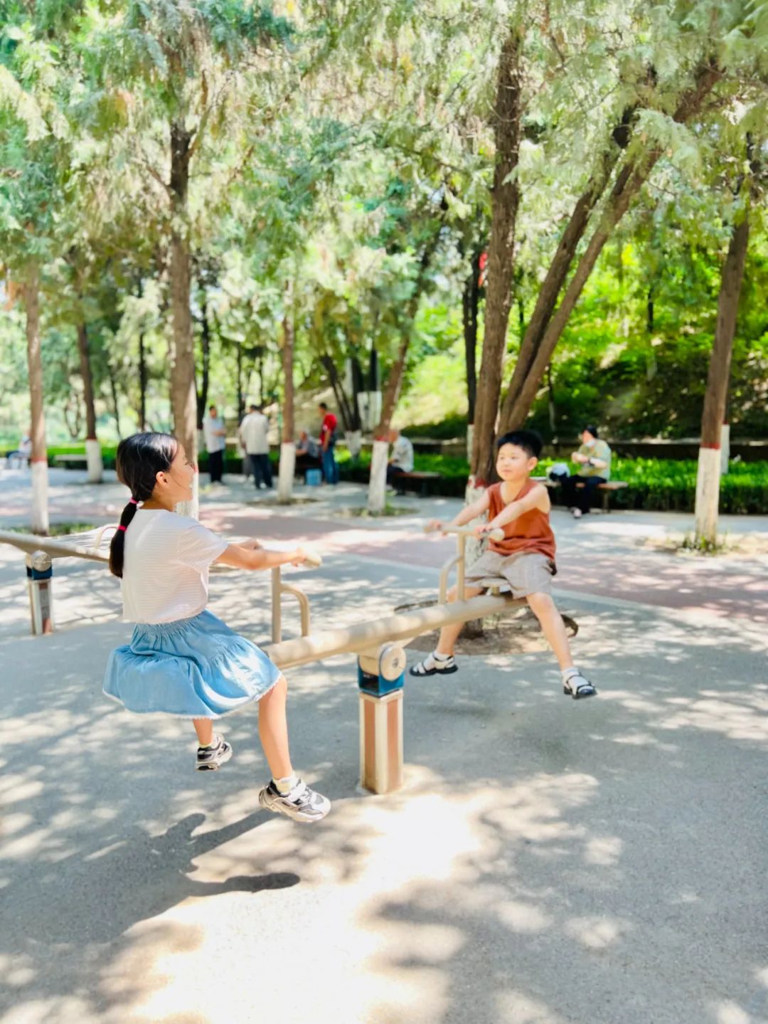 两个小朋友开心地玩着跷跷板.