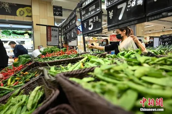 资料图：超市内的货架上摆满了蔬菜。陈超 摄
