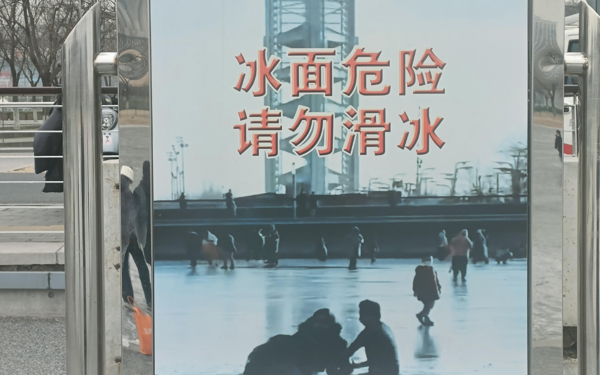 奥林匹克公园龙形水系旁设置的"冰面危险,请勿滑冰"警示语.