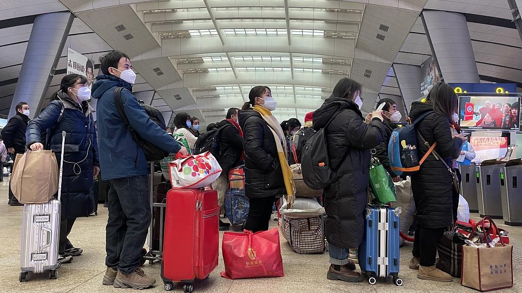 2023年1月12日,北京南站许多旅客拖着沉甸甸的行李箱,准备踏上回家的