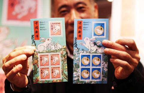 1月14日，在法国巴黎举行的兔年生肖邮票发行仪式上，邮票设计者陈江洪展示兔年生肖纪念邮票。新华社记者 高静 摄