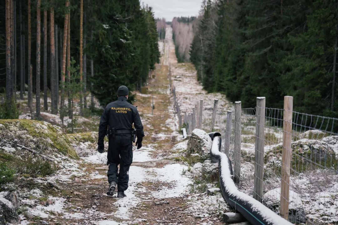 ▲一名芬兰边境官员站在芬兰-俄罗斯边境围栏前（法新社资料图片）