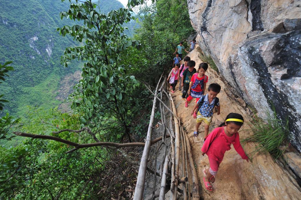 在广西大化瑶族自治县板升乡弄雷村哈保屯,孩子们走在悬崖边的上学路