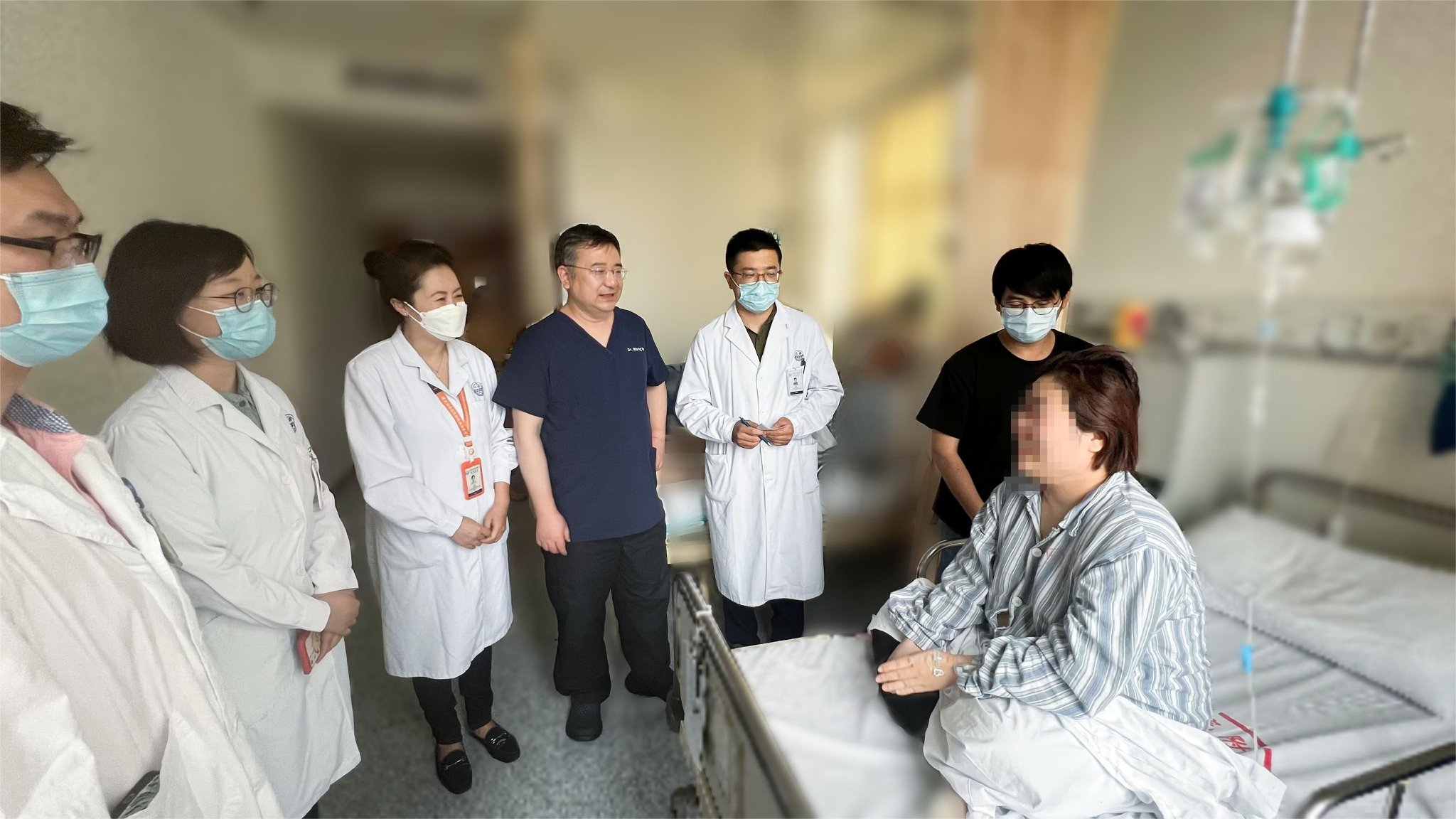 术后，专家团队看望患者。上海交大医学院附属仁济医院 供图
