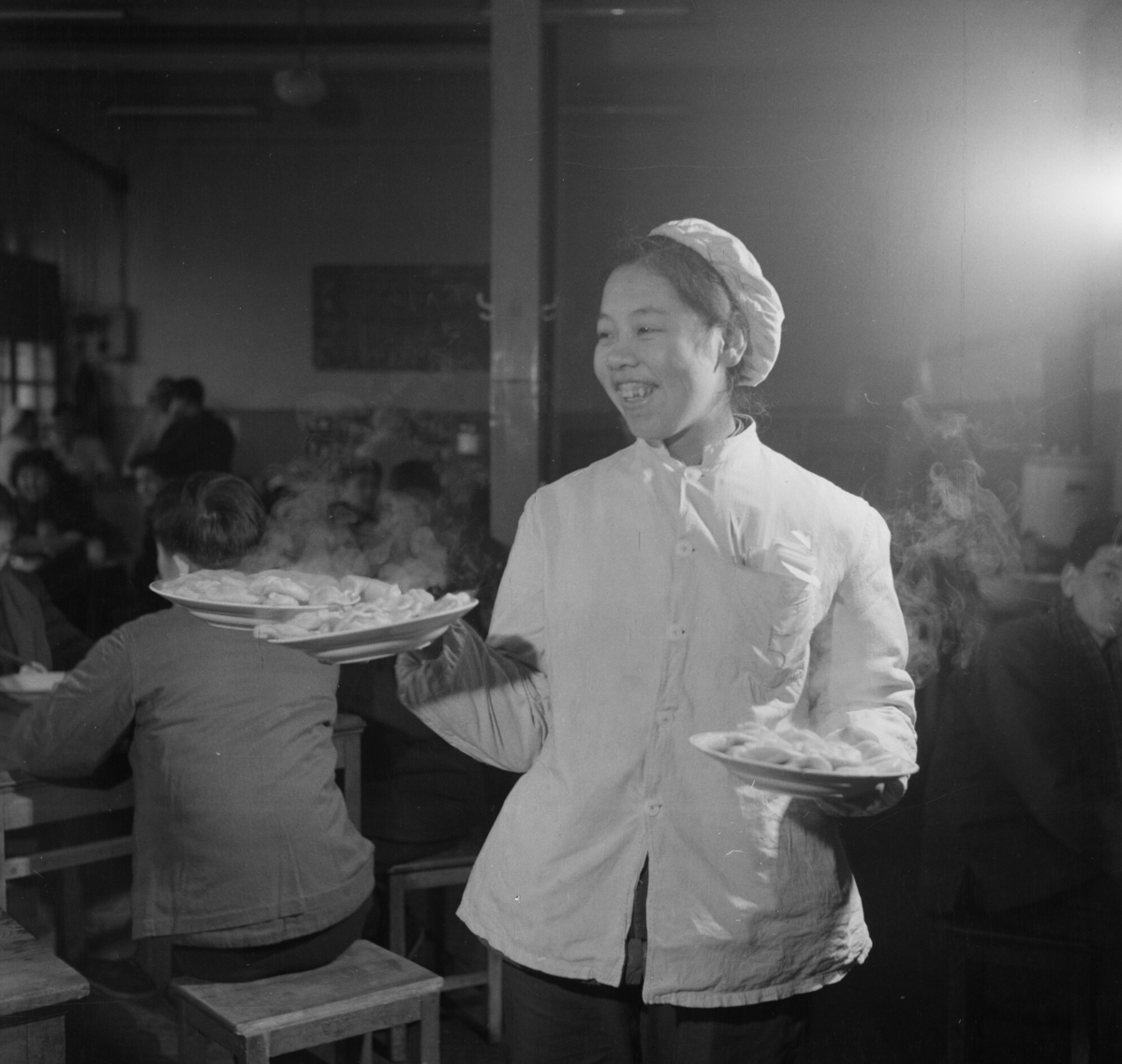 1964年大年夜,饭馆服务员为顾客端上热气腾腾的水饺.高宏摄