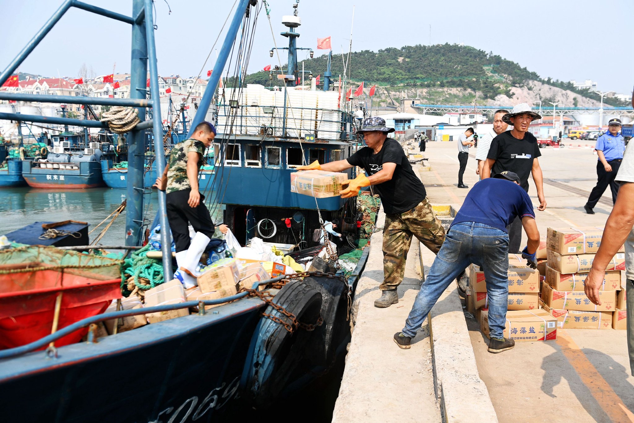 9月1日,青岛积米崖渔港,渔民在给渔船补给物品.俞方平 摄