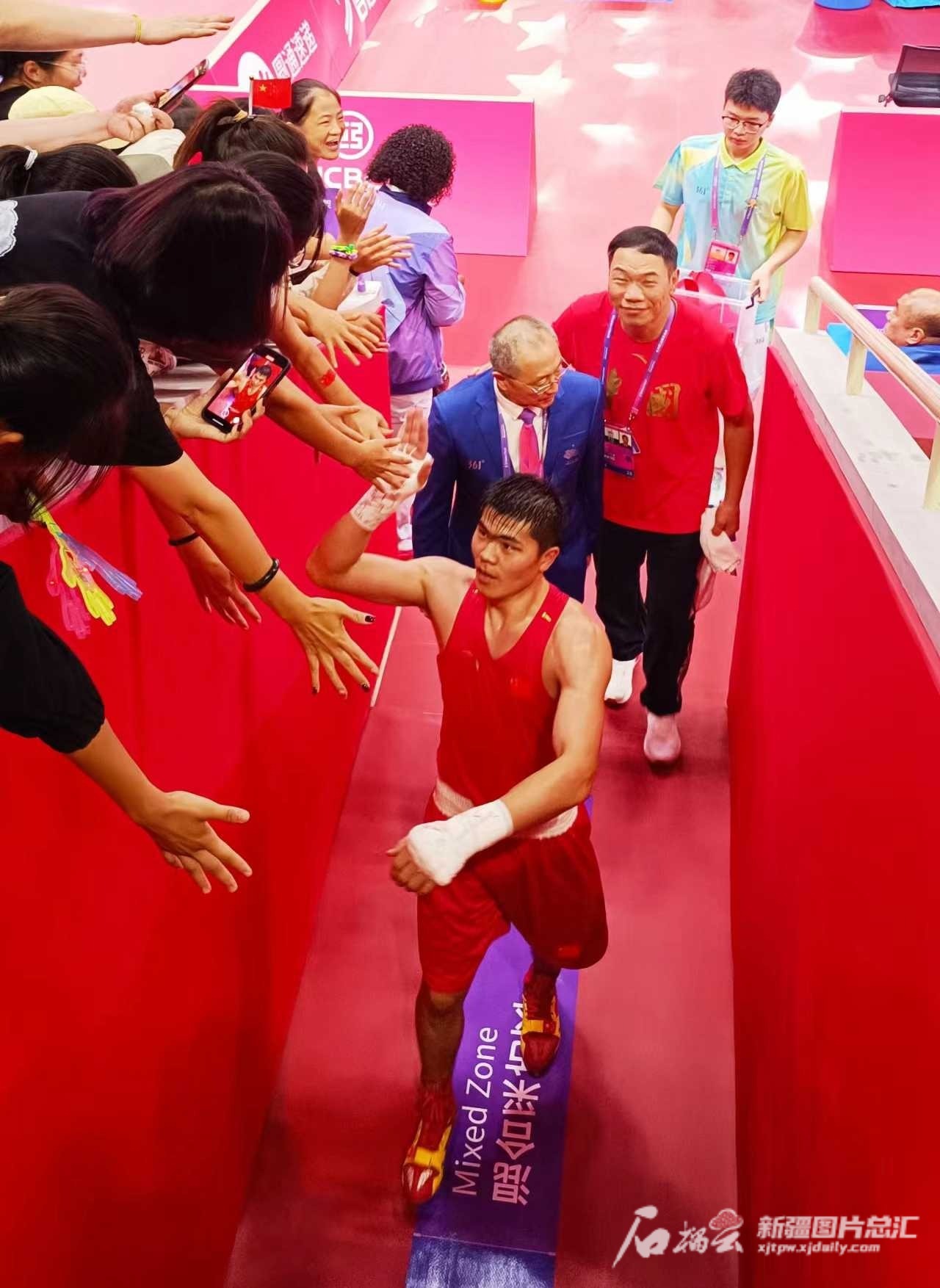 托合塔尔别克·唐拉提汗获胜后与观众击掌庆祝.