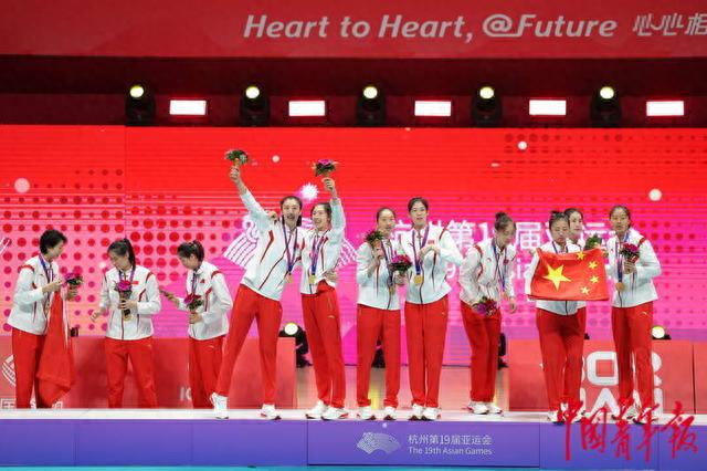 10月7日，杭州，亚运会女排决赛颁奖仪式，中国队员庆祝后将国旗叠好。中青报·中青网记者 李隽辉/摄