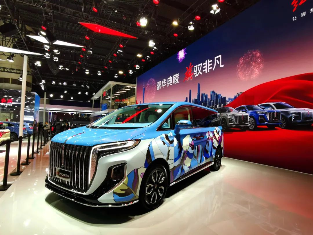 广州车展上,一辆披着彩绘涂装的红旗hq9在展台中央.