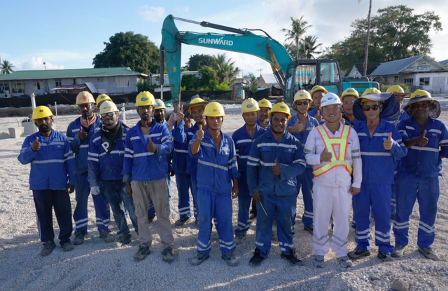 1月18日，瑙鲁艾沃港码头升级改造项目工地的中瑙员工合影。新华社记者 王申摄