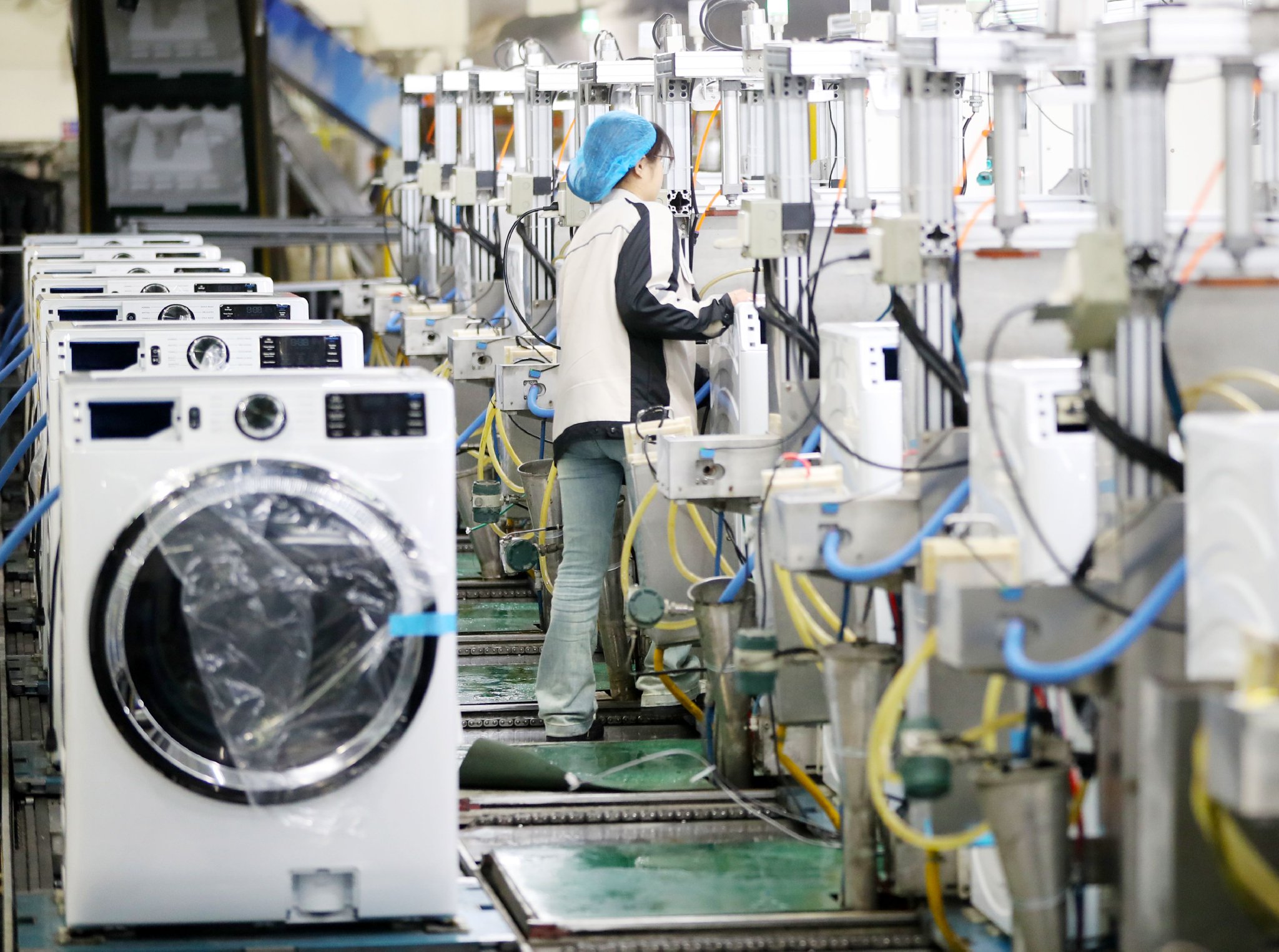 2月18日，位于青岛自贸片区的海尔青岛洗衣机互联工厂，工人对刚下线的洗衣机进行智能检测。张进刚 摄