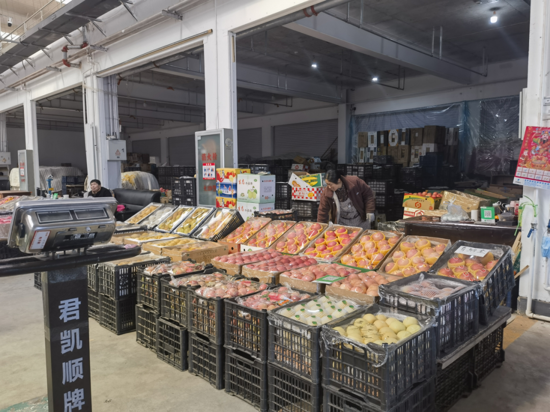 图为新发地盘锦分市场果品交易区商户在整理水果.