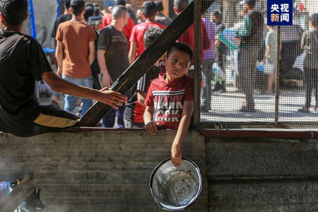 △当地时间4月4日，加沙地带拉法，包括儿童在内的巴勒斯坦人和他们的家人一起避难，他们排队领取慈善组织分发的食物。