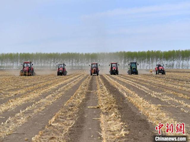 吉林农安，多台农机设备在进行春耕作业。刘栋 摄