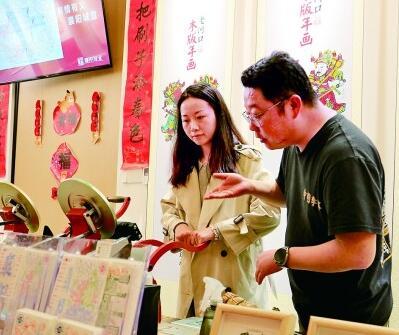 游客在襄阳古城管家巷体验老河口木版年画文创产品制作。本报记者 郭冠东摄