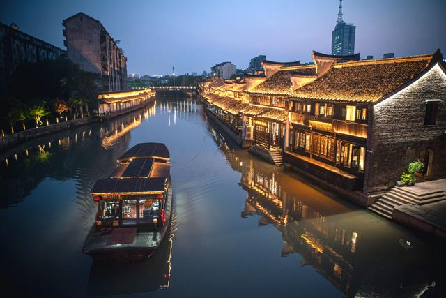4月26日，游船行驶在流经嘉兴市月河历史街区的京杭大运河上。新华社记者 江汉 摄