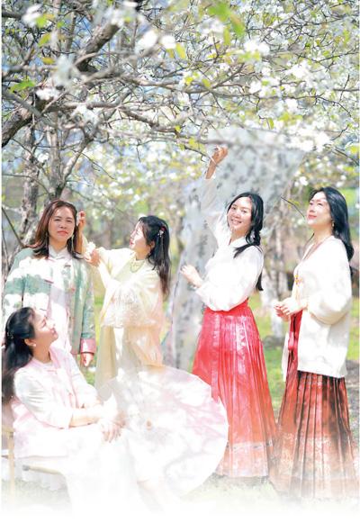 江苏省苏州市，身着华服的游客在中国花卉植物园游玩。王建康摄