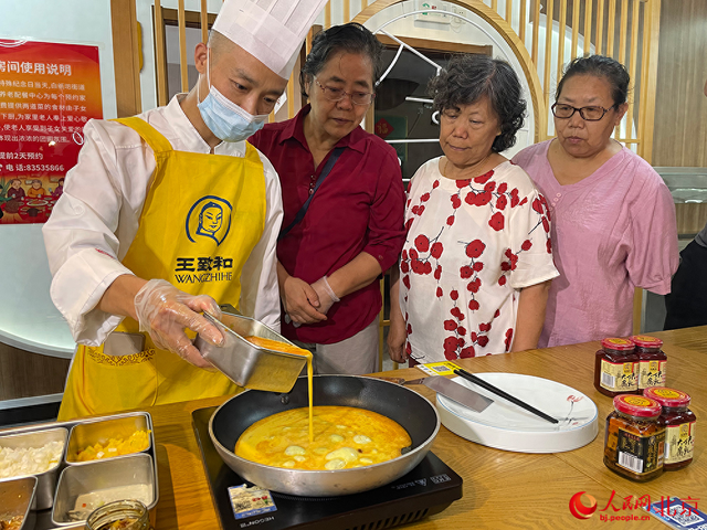 厨师现场为社区居民摊鸡蛋。人民网记者 尹星云 摄