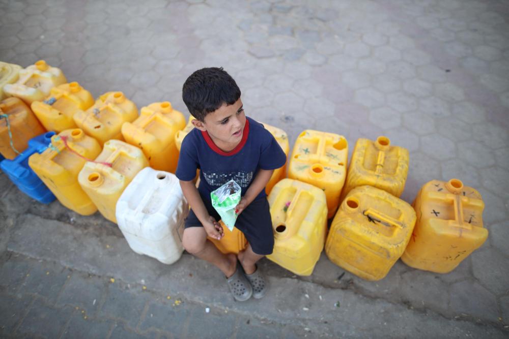 9月3日，在加沙地带中部的努赛赖特难民营，一名儿童坐在塑料桶上。新华社发（马尔万·达乌德摄）