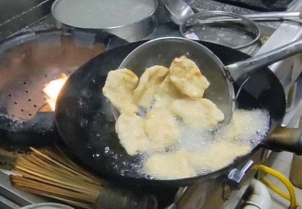 将锅包肉放入锅中复炸。石洪宇 摄
