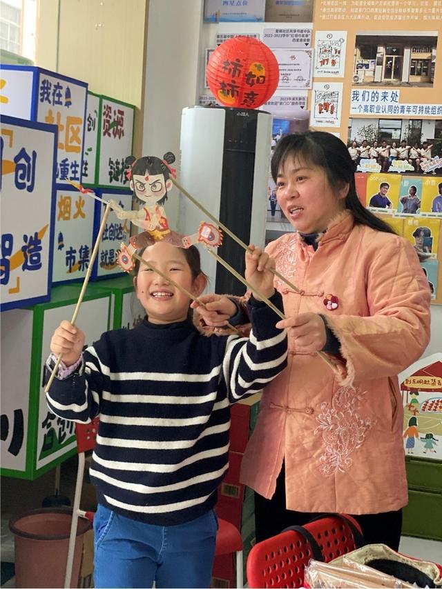 东明社区达人、非遗传承人王荣华在东明街区发展中心开设“小小创意家”课堂，孩子们对皮影很感兴趣。 黄懿莹 图