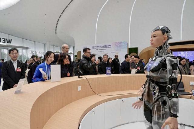 3月27日，2025中关村论坛年会开幕，服务台为嘉宾服务的人形机器人。中青报·中青网记者 李隽辉/摄