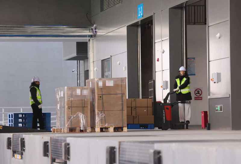 工作人员将首单货物运入保税库。新京报记者 李木易 摄