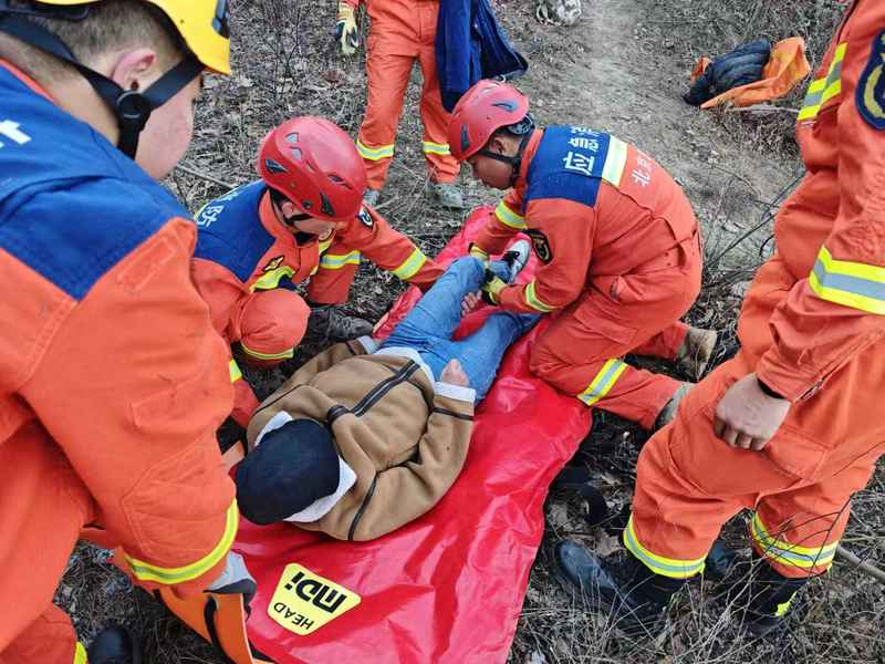 救援人员小心翼翼将伤者平稳转移至多功能担架，并用躯体固定气囊对其全身进行固定。怀柔消防供图