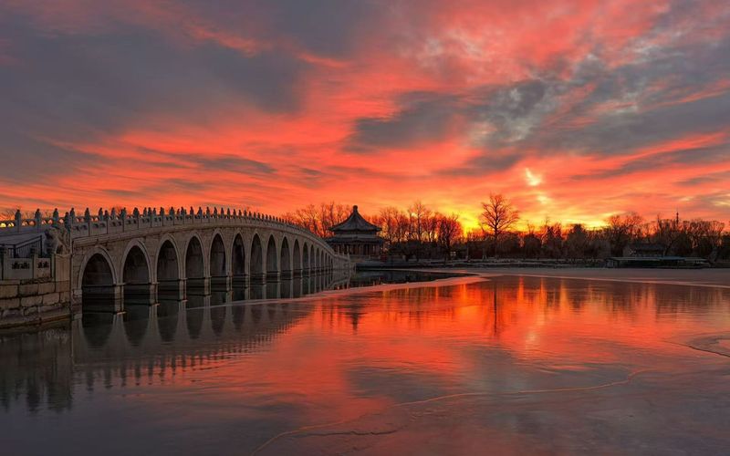 1月7日清晨，漫天彩霞与十七孔桥同框。颐和园供图
