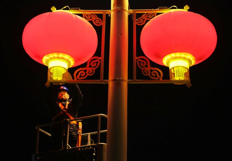 国网北京电力城市照明管理中心工作人员维护大红灯笼灯饰。新京报记者 李木易 摄